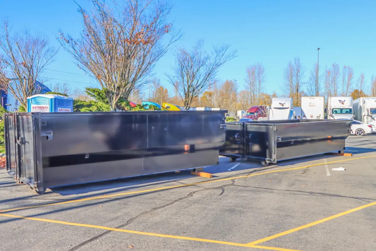 Professional dumpster rental service with roll-off container on residential driveway in Reading